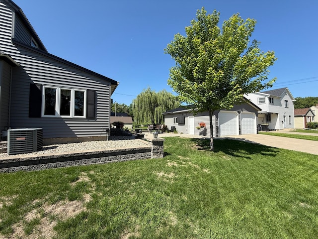 411 Vernon Ave, Morgan, MN 56266 - view of grassy yard featuring a garage and driveway