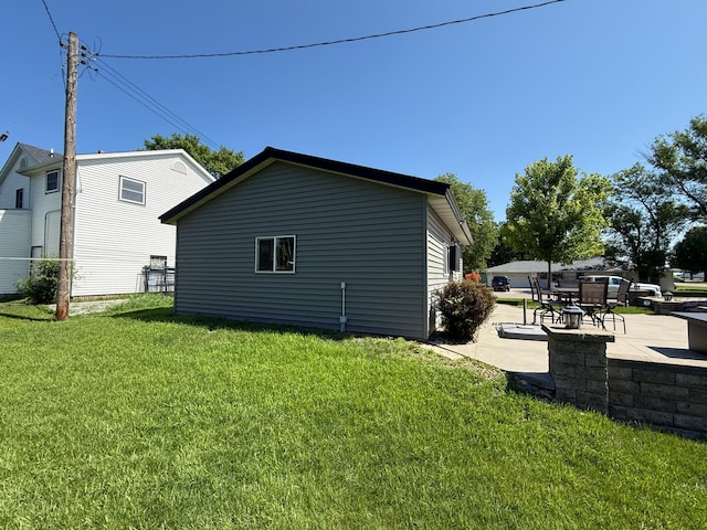 411 Vernon Ave, Morgan, MN 56266 - view of side of home featuring a lawn and a patio