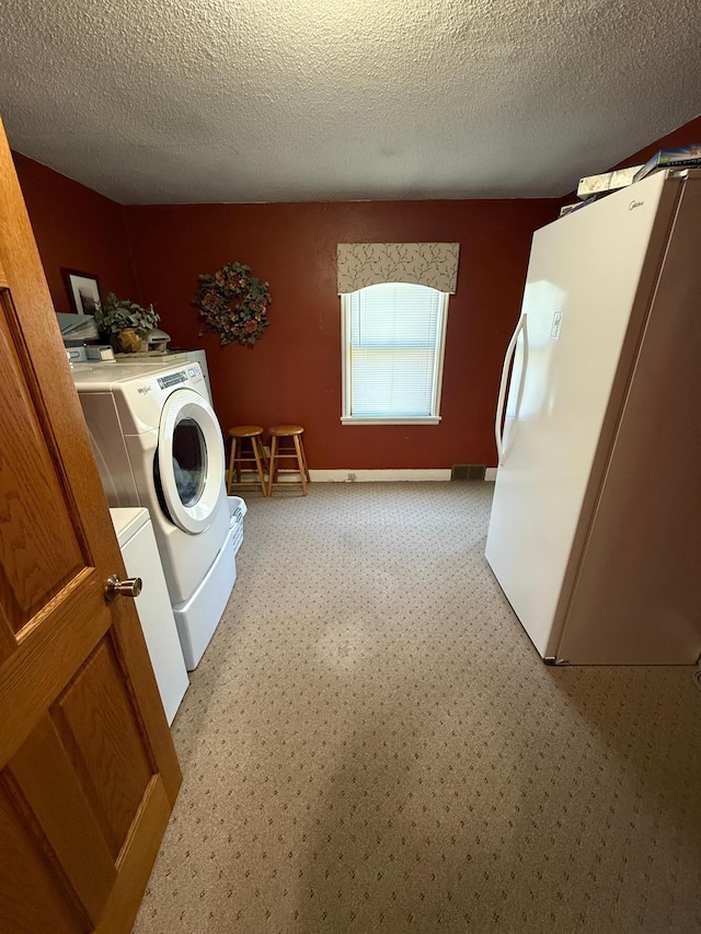 411 Vernon Ave, Morgan, MN 56266 - washroom featuring independent washer and dryer, a textured ceiling, and light colored carpet