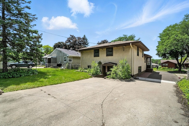 1464 Kent St, Saint Paul, MN 55117 - back of property with driveway and stucco siding