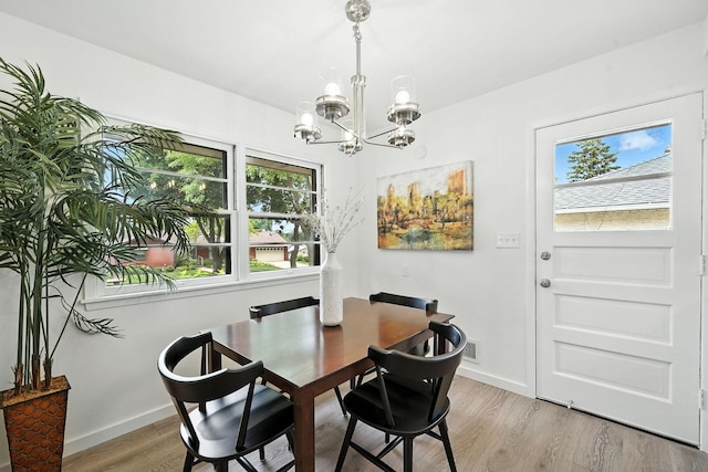 1464 Kent St, Saint Paul, MN 55117 - dining space featuring a chandelier and light wood finished floors