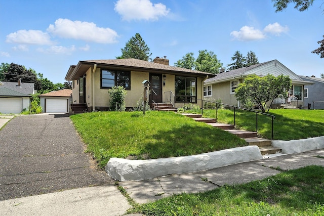 1464 Kent St, Saint Paul, MN 55117 - bungalow featuring a detached garage, a chimney, a front yard, and stucco siding