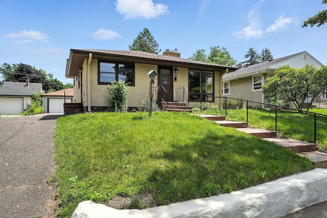1464 Kent St, Saint Paul, MN 55117 - view of front of house with a chimney, stucco siding, and a detached garage