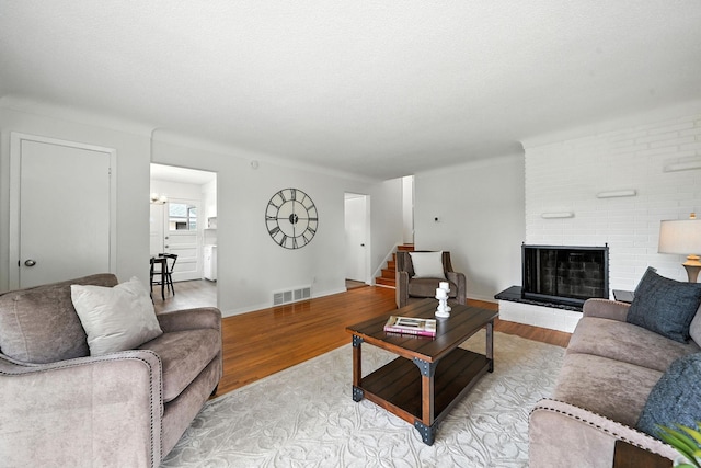 1464 Kent St, Saint Paul, MN 55117 - living room featuring light wood-style floors, stairway, and a fireplace