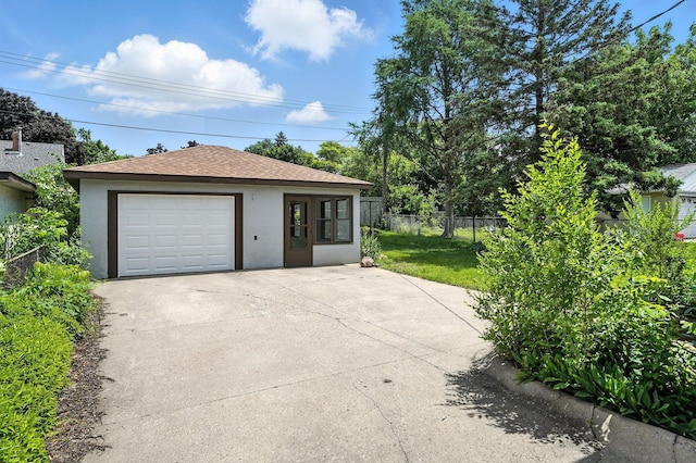 1464 Kent St, Saint Paul, MN 55117 - view of front of property featuring stucco siding, a detached garage, driveway, an outdoor structure, and roof with shingles