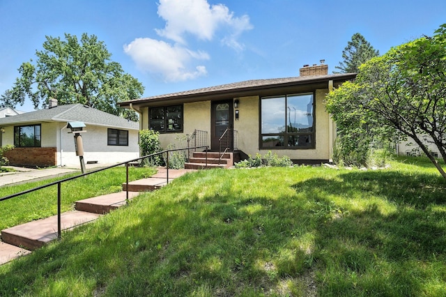 1464 Kent St, Saint Paul, MN 55117 - view of front of property with a chimney, a front lawn, and stucco siding