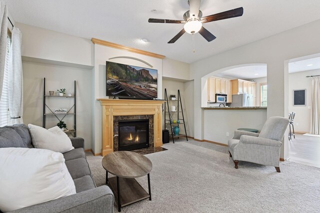 8356 Townsend Dr, Eden Prairie, MN 55344 - carpeted living area with a ceiling fan, a high end fireplace, and arched walkways