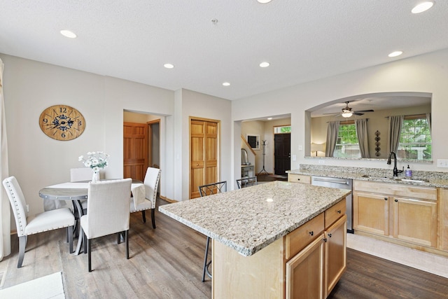 8356 Townsend Dr, Eden Prairie, MN 55344 - kitchen with stainless steel dishwasher, dark wood-type flooring, arched walkways, light stone countertops, and a ceiling fan