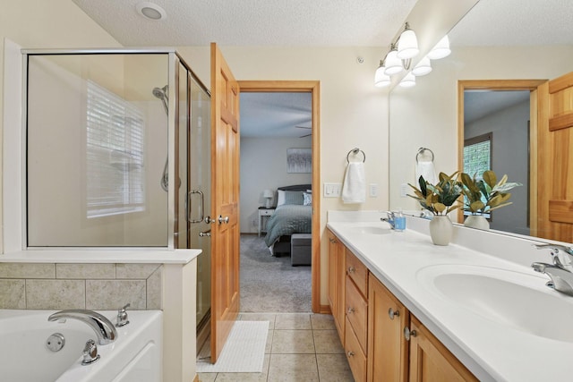 8356 Townsend Dr, Eden Prairie, MN 55344 - ensuite bathroom featuring a shower stall, double vanity, a textured ceiling, a garden tub, and tile patterned floors