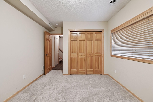 8356 Townsend Dr, Eden Prairie, MN 55344 - unfurnished bedroom with carpet floors, a textured ceiling, and a closet