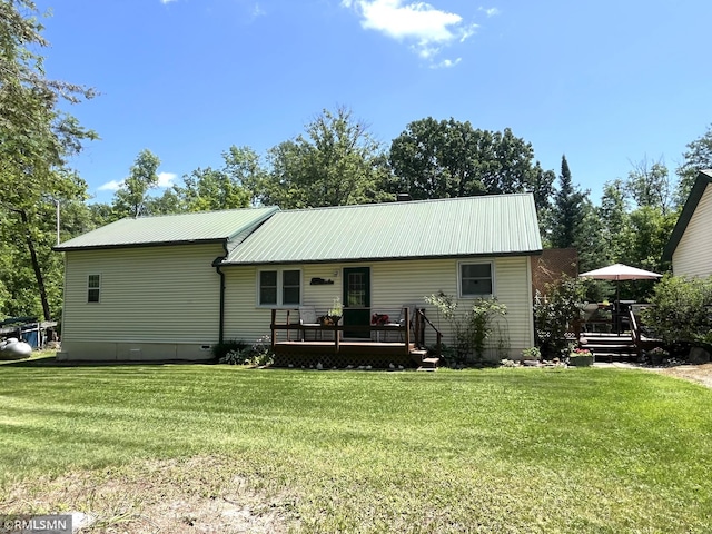 37452 Deer St, Aitkin, MN 56431 - rear view of house with a wooden deck, a yard, and a metal roof
