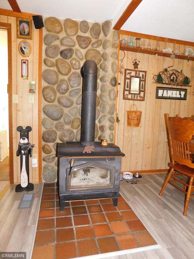 37452 Deer St, Aitkin, MN 56431 - detailed view of wood finished floors, wood walls, and a wood stove