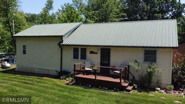 37452 Deer St, Aitkin, MN 56431 - back of property with a wooden deck, a lawn, a metal roof, and crawl space