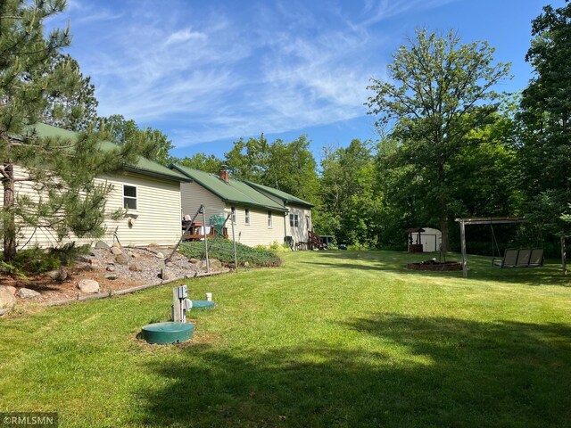 37452 Deer St, Aitkin, MN 56431 - view of grassy yard featuring a storage shed