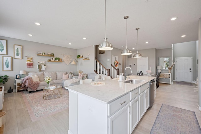 18874 72nd Pl N, Maple Grove, MN 55311 - kitchen with light wood finished floors, stainless steel dishwasher, white cabinetry, recessed lighting, and a kitchen island with sink