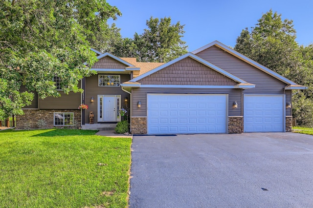 40224 Golden Way, North Branch, MN 55056 - view of front facade featuring stone siding, driveway, a front lawn, and a garage
