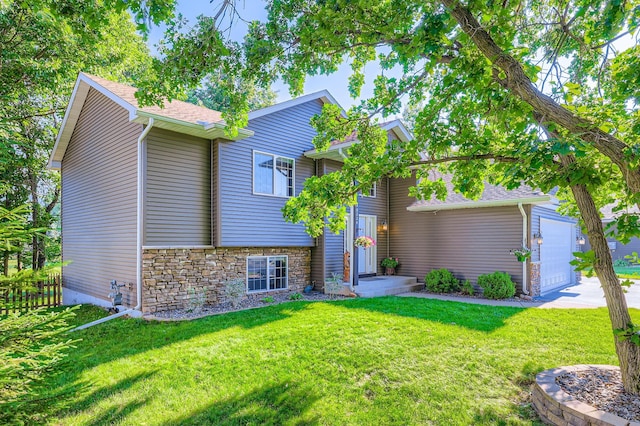 40224 Golden Way, North Branch, MN 55056 - view of front of house with an attached garage, stone siding, a front yard, and concrete driveway