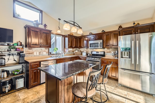 40224 Golden Way, North Branch, MN 55056 - kitchen featuring stainless steel appliances, tasteful backsplash, high vaulted ceiling, a kitchen island, and a kitchen breakfast bar