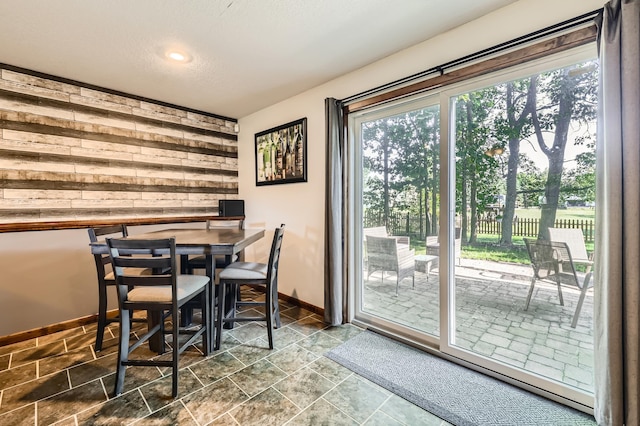 40224 Golden Way, North Branch, MN 55056 - dining area featuring healthy amount of natural light, wood walls, recessed lighting, and a textured ceiling