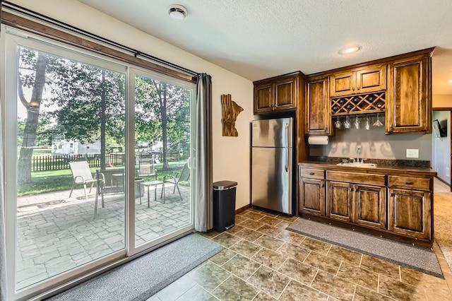 40224 Golden Way, North Branch, MN 55056 - kitchen with freestanding refrigerator, dark countertops, and a textured ceiling