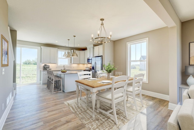 2885 Trinity Dr, Shakopee, MN 55379 - dining room with light wood-style floors and a chandelier