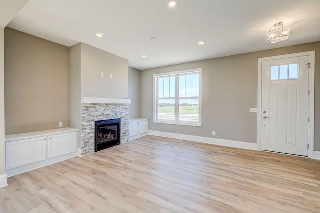 2885 Trinity Dr, Shakopee, MN 55379 - unfurnished living room with light wood-style flooring, plenty of natural light, a fireplace, and recessed lighting