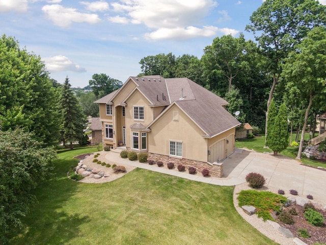 15208 Fairway Heights Rd NW, Prior Lake, MN 55372 - traditional-style home featuring stucco siding, stone siding, concrete driveway, a garage, and a front yard