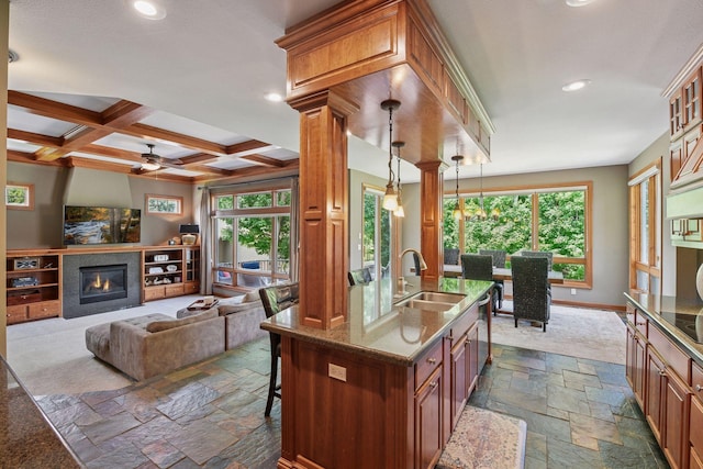 15208 Fairway Heights Rd NW, Prior Lake, MN 55372 - kitchen with stone tile floors, recessed lighting, stone counters, brown cabinets, and ceiling fan
