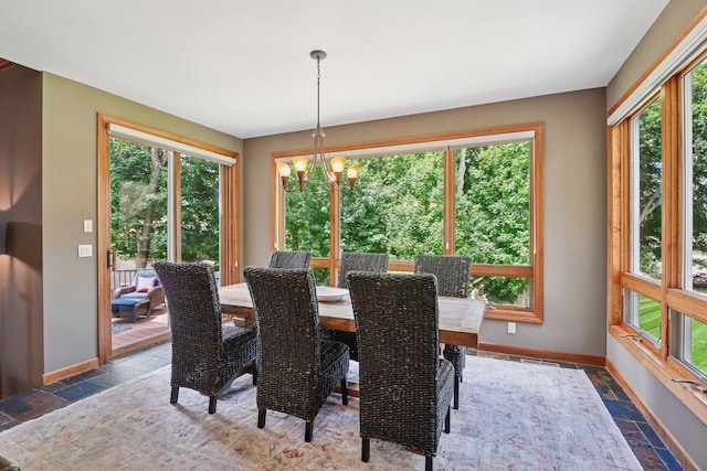 15208 Fairway Heights Rd NW, Prior Lake, MN 55372 - dining space with stone tile floors, plenty of natural light, and a chandelier