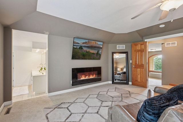 15208 Fairway Heights Rd NW, Prior Lake, MN 55372 - living room with light colored carpet, a glass covered fireplace, and a ceiling fan