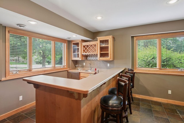 15208 Fairway Heights Rd NW, Prior Lake, MN 55372 - indoor wet bar with recessed lighting, backsplash, and dark stone finish floors