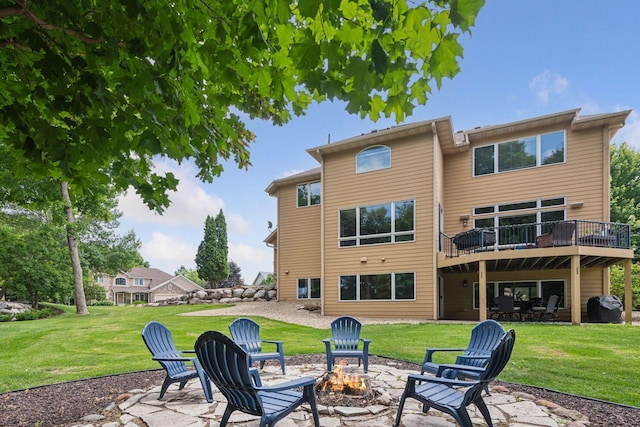 15208 Fairway Heights Rd NW, Prior Lake, MN 55372 - back of property with a fire pit, a patio, a yard, and a wooden deck