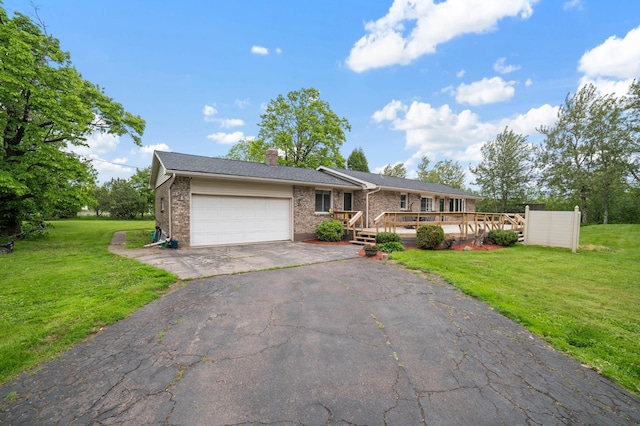 5510 Thompson Hill Rd, Proctor, MN 55810 - ranch-style house featuring an attached garage, asphalt driveway, a chimney, brick siding, and a front lawn