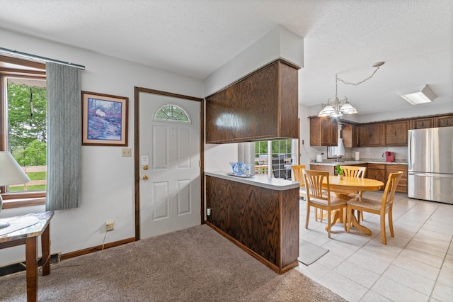 5510 Thompson Hill Rd, Proctor, MN 55810 - foyer entrance with plenty of natural light, a textured ceiling, a chandelier, and light tile patterned floors