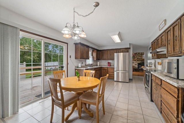 5510 Thompson Hill Rd, Proctor, MN 55810 - dining area featuring a chandelier, light tile patterned flooring, and a textured ceiling