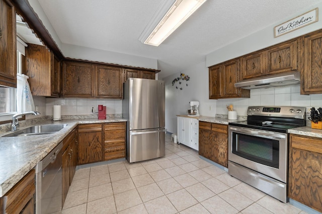 5510 Thompson Hill Rd, Proctor, MN 55810 - kitchen with appliances with stainless steel finishes, exhaust hood, backsplash, and light tile patterned floors
