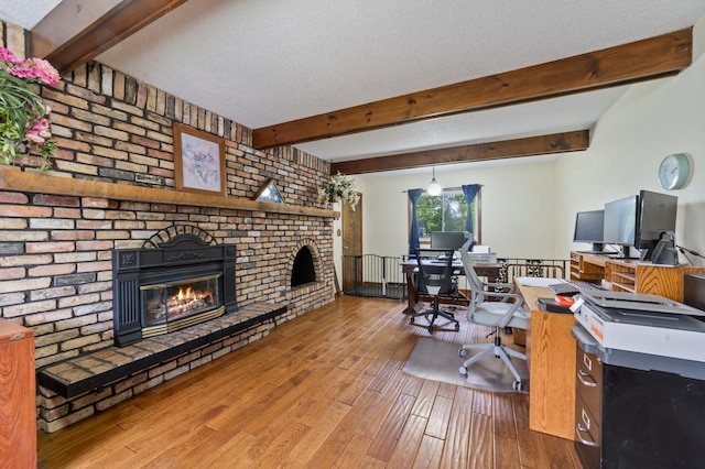 5510 Thompson Hill Rd, Proctor, MN 55810 - office space featuring a brick fireplace, wood finished floors, beam ceiling, and a textured ceiling