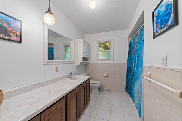 5510 Thompson Hill Rd, Proctor, MN 55810 - bathroom featuring tile walls, tile patterned floors, vanity, a textured ceiling, and wainscoting