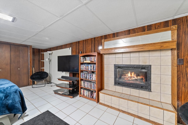 5510 Thompson Hill Rd, Proctor, MN 55810 - tiled bedroom featuring wooden walls, a tile fireplace, and a closet