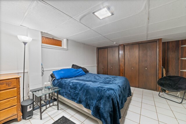 5510 Thompson Hill Rd, Proctor, MN 55810 - bedroom with light tile patterned flooring, a paneled ceiling, and two closets