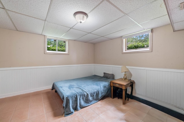 5510 Thompson Hill Rd, Proctor, MN 55810 - bedroom featuring a paneled ceiling, a wainscoted wall, multiple windows, and tile patterned flooring