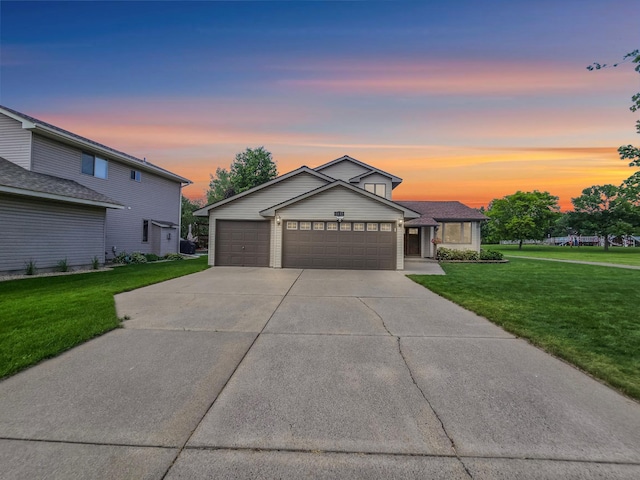 4619 Heather Way N, Oakdale, MN 55128 - traditional-style house featuring a yard, driveway, and a garage