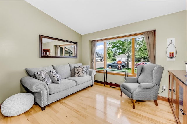 4619 Heather Way N, Oakdale, MN 55128 - living area featuring vaulted ceiling and light wood-style floors