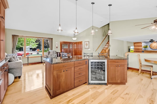 4619 Heather Way N, Oakdale, MN 55128 - kitchen featuring beverage cooler, open floor plan, light wood-type flooring, dark stone countertops, and high vaulted ceiling