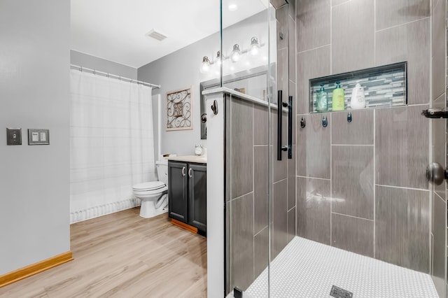 4619 Heather Way N, Oakdale, MN 55128 - full bathroom with tiled shower, vanity, and wood finished floors