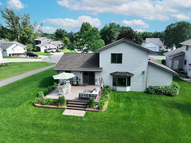 4619 Heather Way N, Oakdale, MN 55128 - rear view of property with a deck, a lawn, a residential view, and a shingled roof