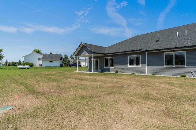 607 Colfax St, Parkers Prairie, MN 56361 - rear view of property with a yard and a shingled roof
