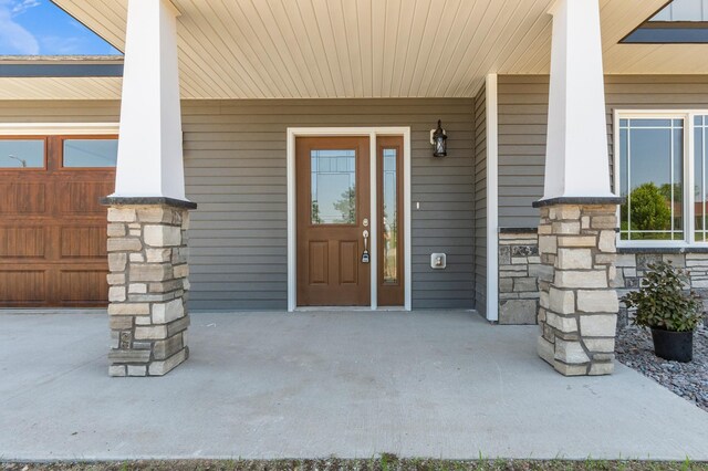 607 Colfax St, Parkers Prairie, MN 56361 - view of exterior entry featuring a porch and stone siding
