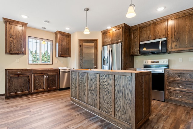607 Colfax St, Parkers Prairie, MN 56361 - kitchen featuring appliances with stainless steel finishes, wood finished floors, a center island, decorative light fixtures, and recessed lighting