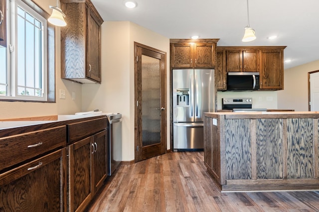 607 Colfax St, Parkers Prairie, MN 56361 - kitchen with stainless steel appliances, dark wood finished floors, decorative light fixtures, and recessed lighting